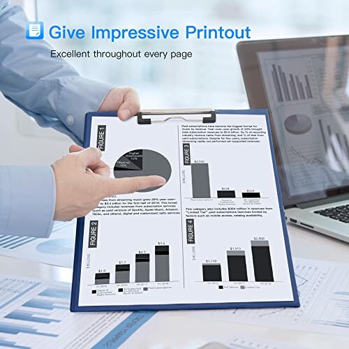 Person pointing at graphs on a clipboard in an office setting.