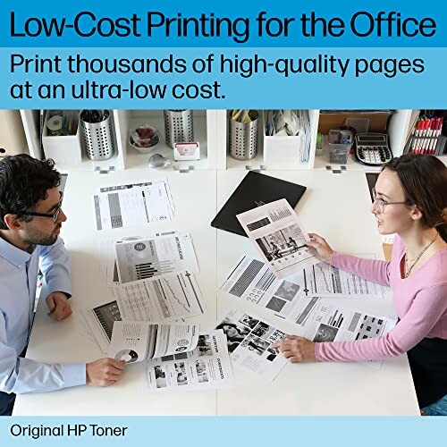 Two people discussing printed documents in an office setting, emphasizing low-cost printing.